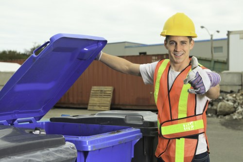 Waste materials being loaded into a builders skip in Hendon